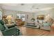 Spacious living room featuring hardwood floors, large windows, and comfortable furniture at 6007 Vivienda Dr # 29, Bradenton, FL 34207