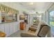 Bright sunroom with wood paneling, a ceiling fan, and comfortable recliner chairs at 6007 Vivienda Dr # 29, Bradenton, FL 34207
