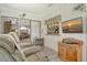 Comfortable sunroom with hardwood flooring, a mounted TV, and a cozy fireplace at 6007 Vivienda Dr # 29, Bradenton, FL 34207