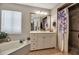 Bathroom featuring a shower with patterned curtains, vanity and framed mirror at 6101 34Th W St # 9C, Bradenton, FL 34210