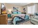 Cozy bedroom with blue metal bed frame, colorful quilt, and a view of a TV at 6101 34Th W St # 9C, Bradenton, FL 34210