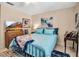 Comfortable bedroom with a blue metal bed frame, TV, and a patterned blanket at 6101 34Th W St # 9C, Bradenton, FL 34210