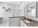 Bright bathroom featuring a glass shower, modern fixtures, and white marble patterned tile at 6532 Copper Ridge Trl, Bradenton, FL 34201