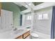 Bright bathroom with modern fixtures including a vanity, toilet, bathtub, and large mirror at 6532 Copper Ridge Trl, Bradenton, FL 34201