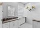 Modern bathroom featuring white cabinets, stylish countertop, glass block window and decorative floral arrangement at 6532 Copper Ridge Trl, Bradenton, FL 34201