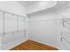 Walk-in closet featuring wood floor and white shelving units at 6532 Copper Ridge Trl, Bradenton, FL 34201