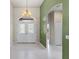 Bright foyer featuring tile flooring, chandelier, and decorative glass double-door entry at 6532 Copper Ridge Trl, Bradenton, FL 34201