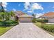 Charming single-story home with a well-manicured lawn, lush landscaping, and a brick paved driveway at 6532 Copper Ridge Trl, Bradenton, FL 34201