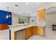 Bright kitchen with light wood cabinets, stainless appliances, and view to the outdoor pool at 6532 Copper Ridge Trl, Bradenton, FL 34201