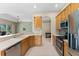 Bright eat-in kitchen features stainless appliances, wooden cabinets, and tile backsplash at 6532 Copper Ridge Trl, Bradenton, FL 34201