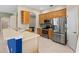 Eat-in kitchen featuring wooden cabinets, stainless appliances, and tile backsplash at 6532 Copper Ridge Trl, Bradenton, FL 34201