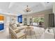 Bright living room with sliding glass doors leading to an outdoor pool area at 6532 Copper Ridge Trl, Bradenton, FL 34201