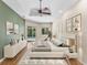 Comfortable main bedroom featuring a ceiling fan, decorative art, and sliding glass door access to the backyard pool at 6532 Copper Ridge Trl, Bradenton, FL 34201