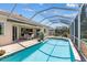 Inviting screened in swimming pool with brick patio and view of the back of the house at 6532 Copper Ridge Trl, Bradenton, FL 34201