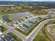 High angle shot of residential neighborhood, highlighting layout, landscaping, and nearby lake at 6708 162Nd E Pl, Parrish, FL 34219