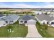 Aerial view of a single-Gathering home highlighting the roof, driveway, and surrounding landscaping at 6708 162Nd E Pl, Parrish, FL 34219