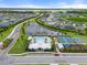 Aerial view of the community amenities featuring a pool, playground, tennis, and basketball courts around a lake at 6708 162Nd E Pl, Parrish, FL 34219