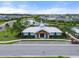 Aerial view of community center, pond, parking, and other neighborhood homes in a well manicured location at 6708 162Nd E Pl, Parrish, FL 34219