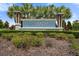 Attractive community sign 'Aviary at Rutti and Ranch' framed by lush landscaping and palm trees at 6708 162Nd E Pl, Parrish, FL 34219