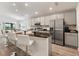Modern kitchen featuring an island with barstool seating and stainless steel appliances at 6708 162Nd E Pl, Parrish, FL 34219