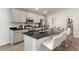 Well-equipped kitchen with an island, sleek cabinetry, stainless steel appliances, and barstool seating at 6708 162Nd E Pl, Parrish, FL 34219