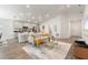 Open-concept living room featuring modern decor, wood floors, and ample natural light at 6708 162Nd E Pl, Parrish, FL 34219