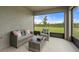 Relaxing covered patio features comfortable seating and a view of the fenced backyard and lush landscaping at 6708 162Nd E Pl, Parrish, FL 34219