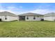 Home's rear exterior featuring a well-kept lawn and an enclosed patio space at 6708 162Nd E Pl, Parrish, FL 34219