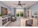 Bright home office with white trim, a ceiling fan, patterned rug, and abundant natural light at 6916 Prairie Oak Way, Nokomis, FL 34275