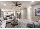 Open-concept living area flows into kitchen, featuring modern furnishings and stylish staircase at 6916 Prairie Oak Way, Nokomis, FL 34275
