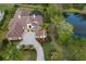 A beautiful aerial view of the house, pool, and landscaping with view of the pond at 7011 Belmont Ct, Lakewood Ranch, FL 34202