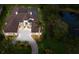 Aerial view of estate with circular driveway and tropical landscaping at 7011 Belmont Ct, Lakewood Ranch, FL 34202