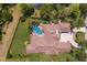 Expansive home aerial view with pool, manicured landscaping, and serene pond in the backyard at 7011 Belmont Ct, Lakewood Ranch, FL 34202