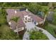 An aerial view of the gorgeous two-story home showcasing the extensive driveway, lush landscaping, and 3-car garage at 7011 Belmont Ct, Lakewood Ranch, FL 34202