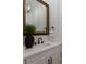 Elegant bathroom vanity with a decorative gold-framed mirror and stylish black fixtures at 7011 Belmont Ct, Lakewood Ranch, FL 34202