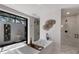 Bright bathroom featuring a soaking tub, a courtyard, and a glass enclosed shower at 7011 Belmont Ct, Lakewood Ranch, FL 34202