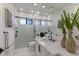 Elegant bathroom with a double vanity, black fixtures, and a walk-in shower with marble-like tile at 7011 Belmont Ct, Lakewood Ranch, FL 34202