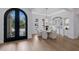 Dining room with a round table, elegant chairs, hardwood floors, and ornate arched entry at 7011 Belmont Ct, Lakewood Ranch, FL 34202