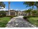 Elegant home featuring a paver driveway and lush, well-maintained landscaping at 7011 Belmont Ct, Lakewood Ranch, FL 34202