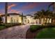 Grand estate with circular driveway, lush landscaping, and Mediterranean architecture at 7011 Belmont Ct, Lakewood Ranch, FL 34202