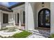 Close-up of the home's entrance, showcasing a fountain, arched doorway and decorative details at 7011 Belmont Ct, Lakewood Ranch, FL 34202