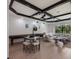 Game room features a shuffleboard table, seating area, and coffered ceilings with modern lighting at 7011 Belmont Ct, Lakewood Ranch, FL 34202