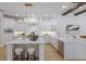 Bright kitchen with two islands, white cabinetry, stainless steel appliances, and elegant light fixtures at 7011 Belmont Ct, Lakewood Ranch, FL 34202