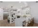 Bright kitchen with stainless steel appliances, large island, and custom white cabinetry at 7011 Belmont Ct, Lakewood Ranch, FL 34202