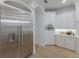 Close-up of stainless steel fridge and white custom cabinets in an elegant kitchen at 7011 Belmont Ct, Lakewood Ranch, FL 34202