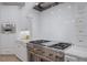 The kitchen has a stainless steel stove with white stone countertops and custom cabinets at 7011 Belmont Ct, Lakewood Ranch, FL 34202