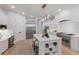 Bright kitchen with stainless steel appliances, large island, and custom white cabinetry at 7011 Belmont Ct, Lakewood Ranch, FL 34202