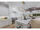 Open-concept kitchen featuring an island, stainless steel stove, and living room view at 7011 Belmont Ct, Lakewood Ranch, FL 34202