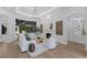 Living room showcasing a fireplace, hardwood floors, and stylish decor overlooking the pool at 7011 Belmont Ct, Lakewood Ranch, FL 34202