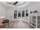 Bright living area with tray ceilings, modern ceiling fan, and black-framed windows overlooking the front yard at 7011 Belmont Ct, Lakewood Ranch, FL 34202